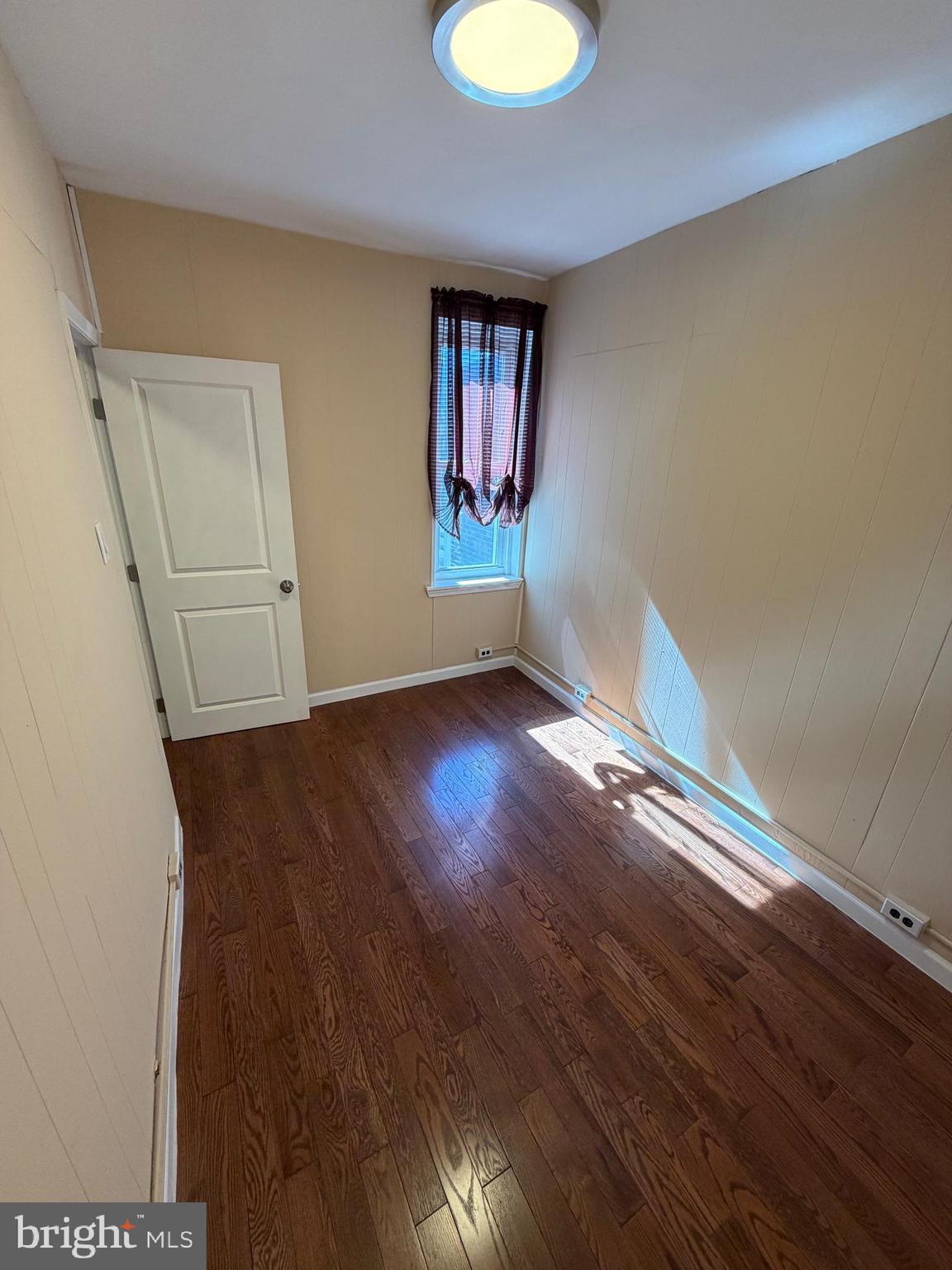 3429 Tilton Street Philadelphia, PA 19134 - Photo 19 of 23 an empty room with wooden floor and window