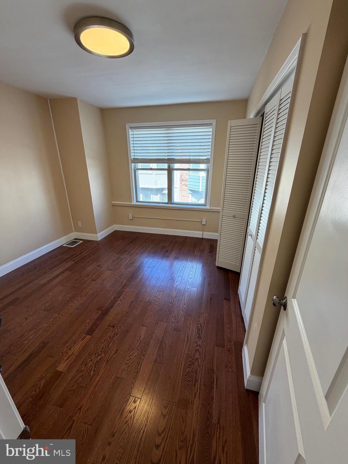 3429 Tilton Street Philadelphia, PA 19134 - Photo 21 of 23 wooden floor in an empty room with a window