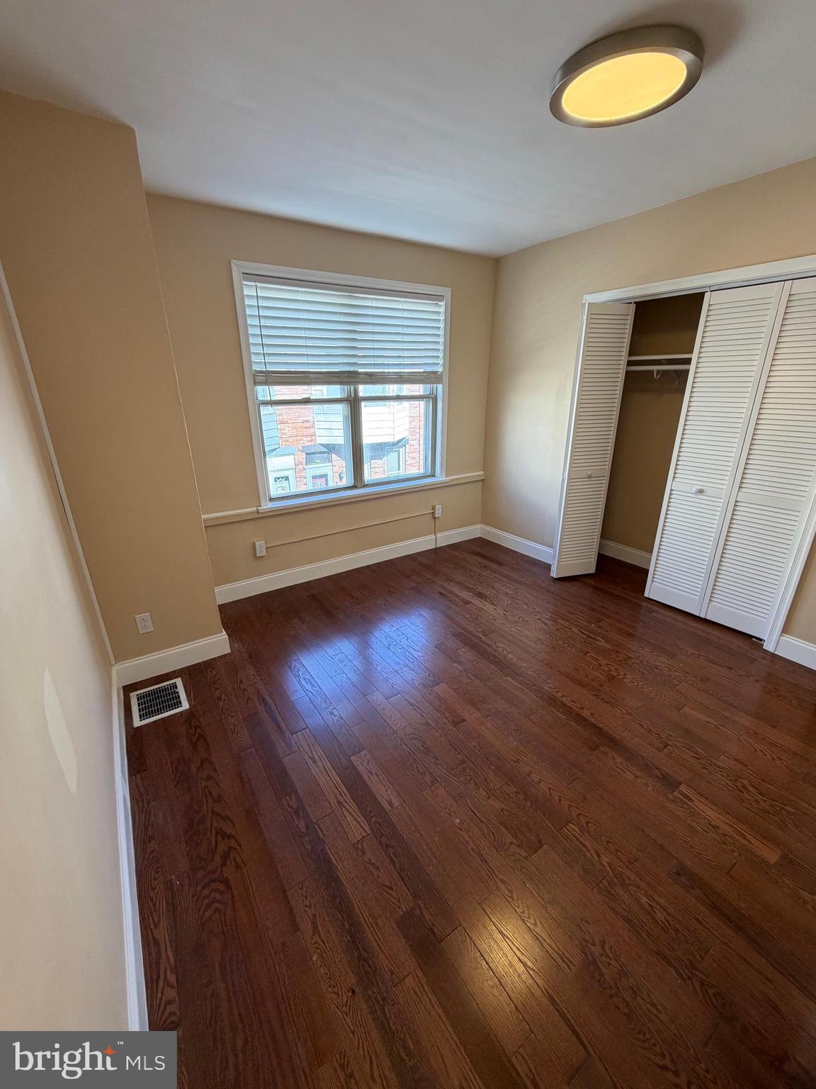 3429 Tilton Street Philadelphia, PA 19134 - Photo 22 of 23 an empty room with wooden floor and windows