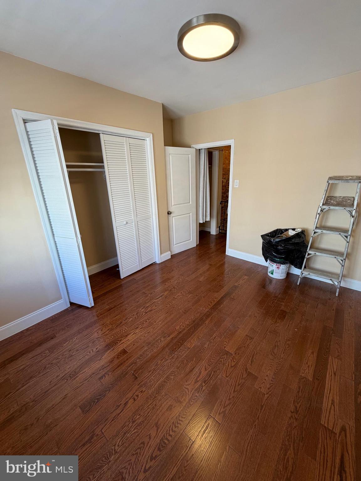 3429 Tilton Street Philadelphia, PA 19134 - Photo 23 of 23 an empty room with wooden floor and lounge chair