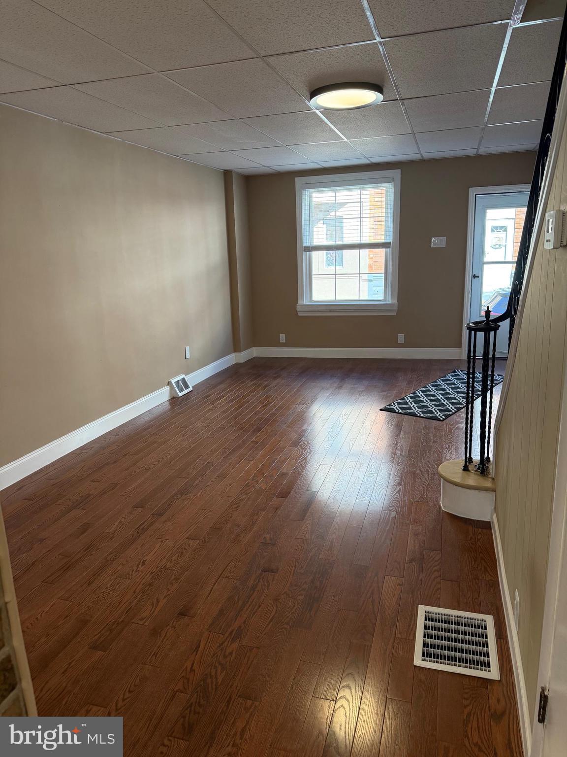 3429 Tilton Street Philadelphia, PA 19134 - Photo 4 of 23 an empty room with wooden floor and windows