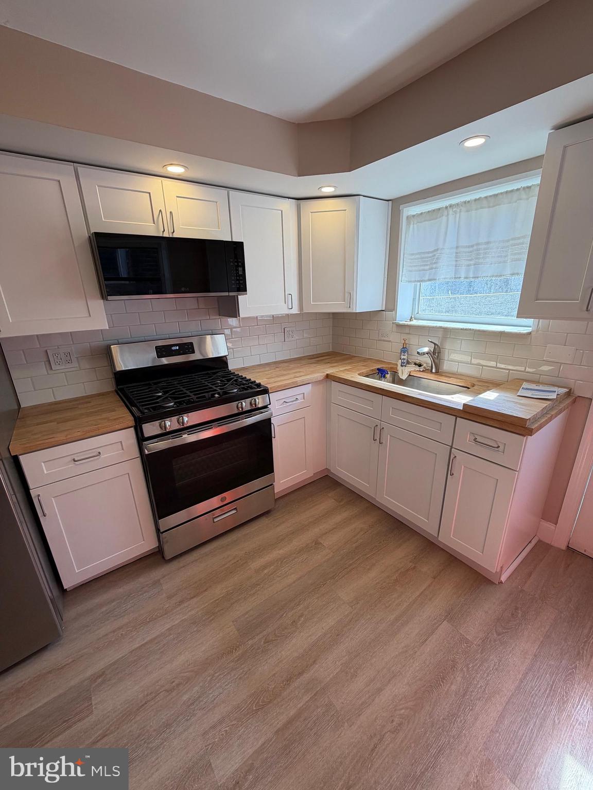 3429 Tilton Street Philadelphia, PA 19134 - Photo 8 of 23 a kitchen with stainless steel appliances a stove a sink and a microwave