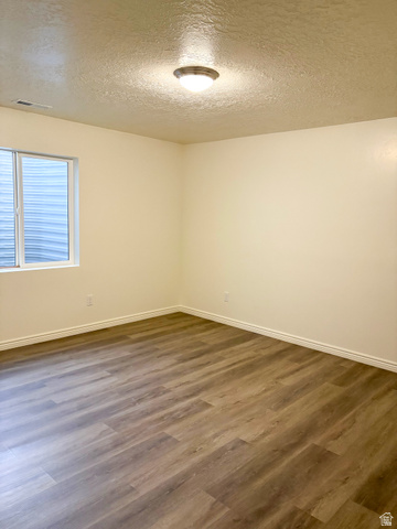 1666 West Foxberry Road Santaquin, UT 84655 - Photo 22 of 23 Spare room with a textured ceiling and dark wood-type flooring