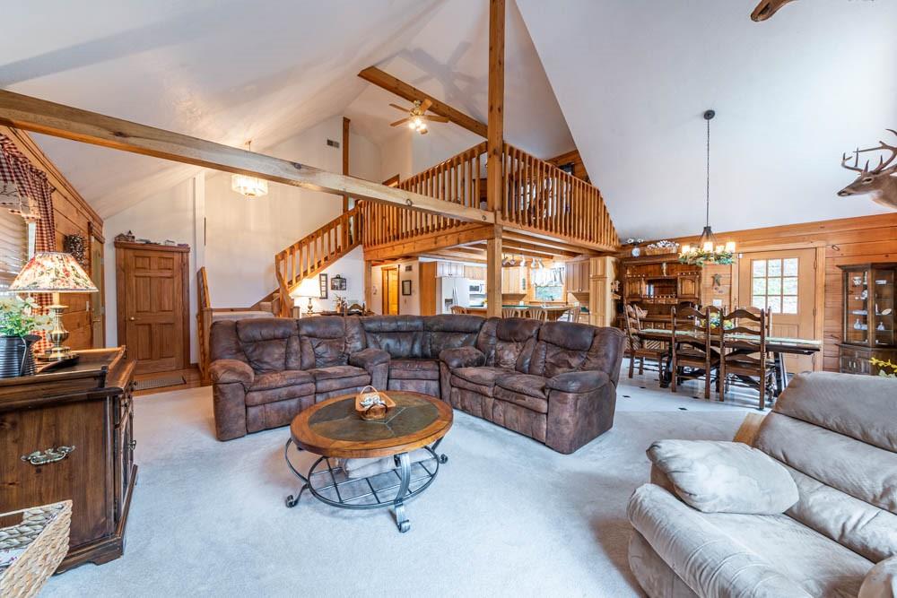155 Glade Run Road Mars, PA 16046 - Photo 9 of 25 a living room with furniture a rug and a chandelier