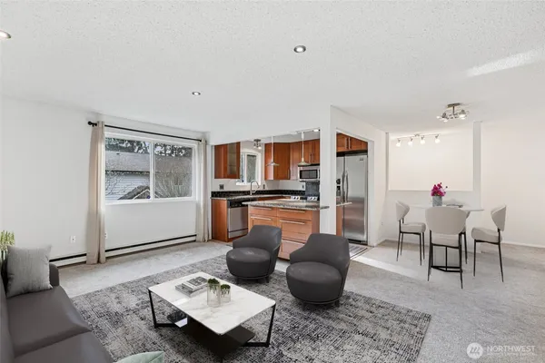 a living room with furniture and kitchen view