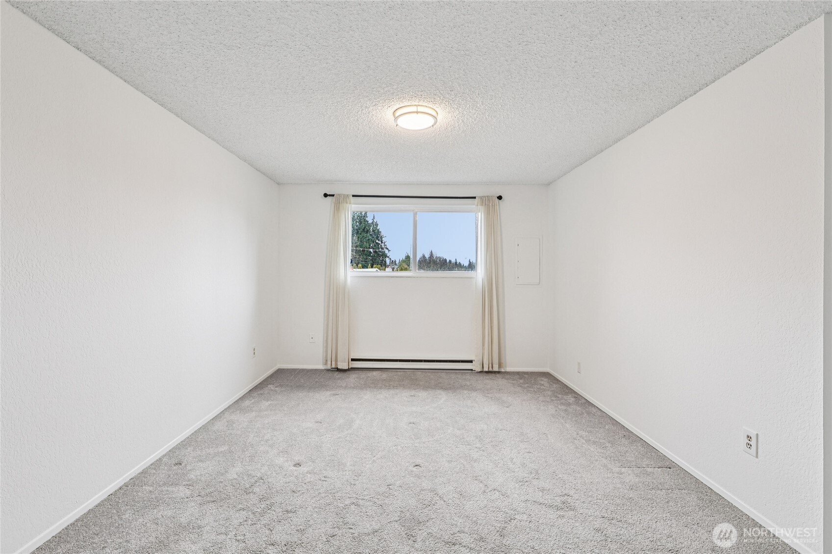 7909 218th Street Southwest, Unit 4 Edmonds, WA 98026 - Photo 17 of 29 an empty room with windows
