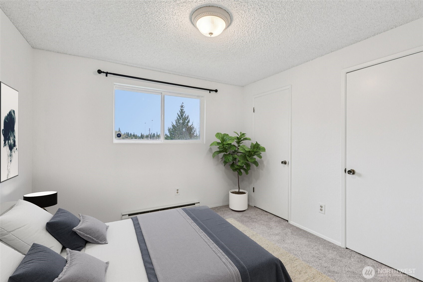 7909 218th Street Southwest, Unit 4 Edmonds, WA 98026 - Photo 20 of 29 a bedroom with a bed and a potted plant