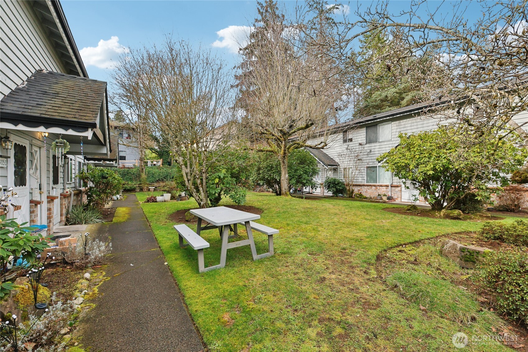 7909 218th Street Southwest, Unit 4 Edmonds, WA 98026 - Photo 26 of 29 a backyard of a house with table and chairs