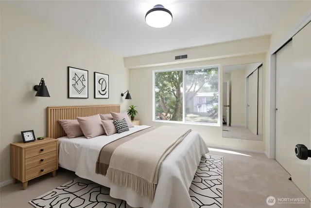 a bedroom with a large bed and a window