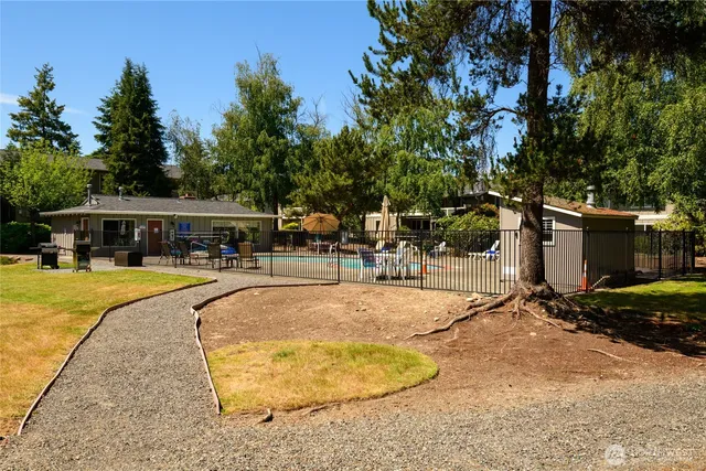 a swimming pool with outdoor seating and yard