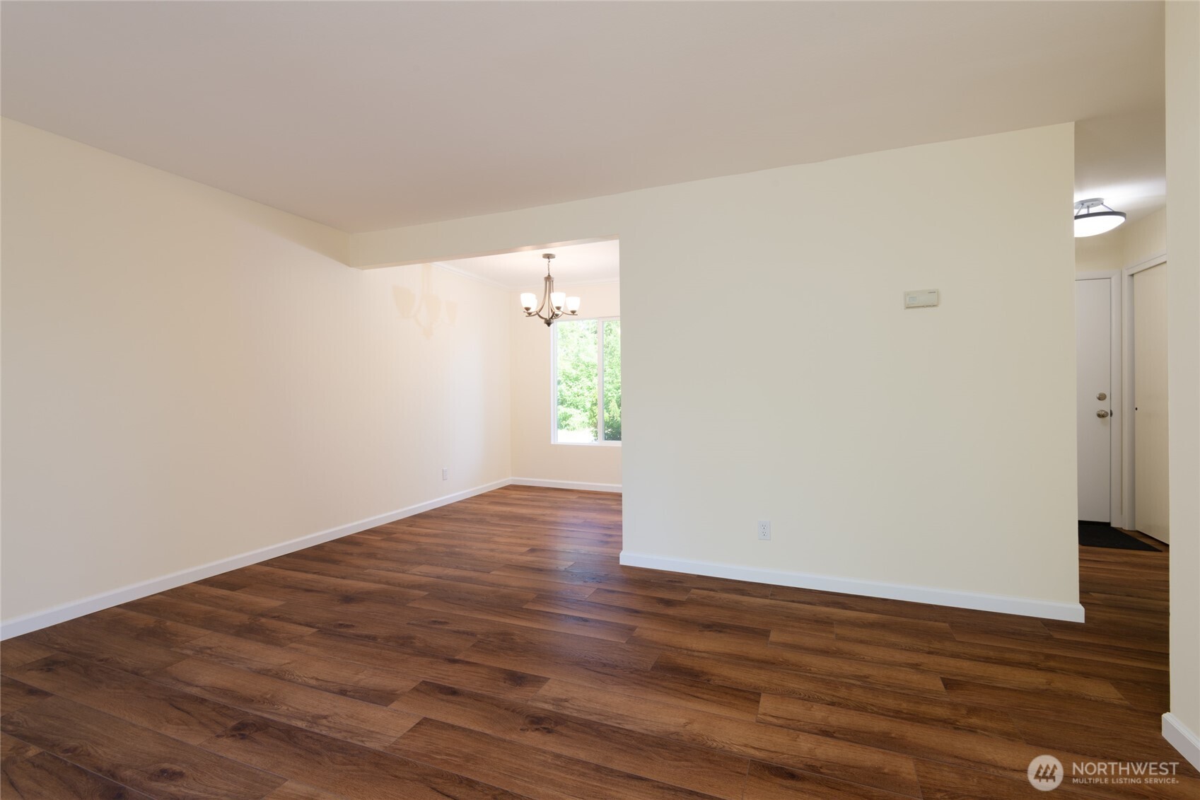 5029 84th Street Southwest Mukilteo, WA 98275 - Photo 5 of 16 a view of an empty room with wooden floor and a window