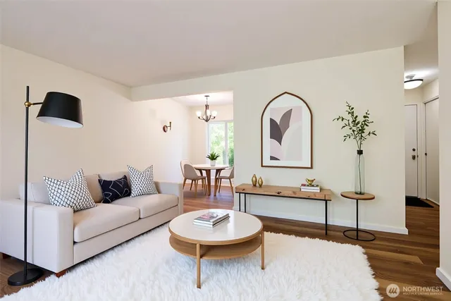 a living room with furniture and a potted plant