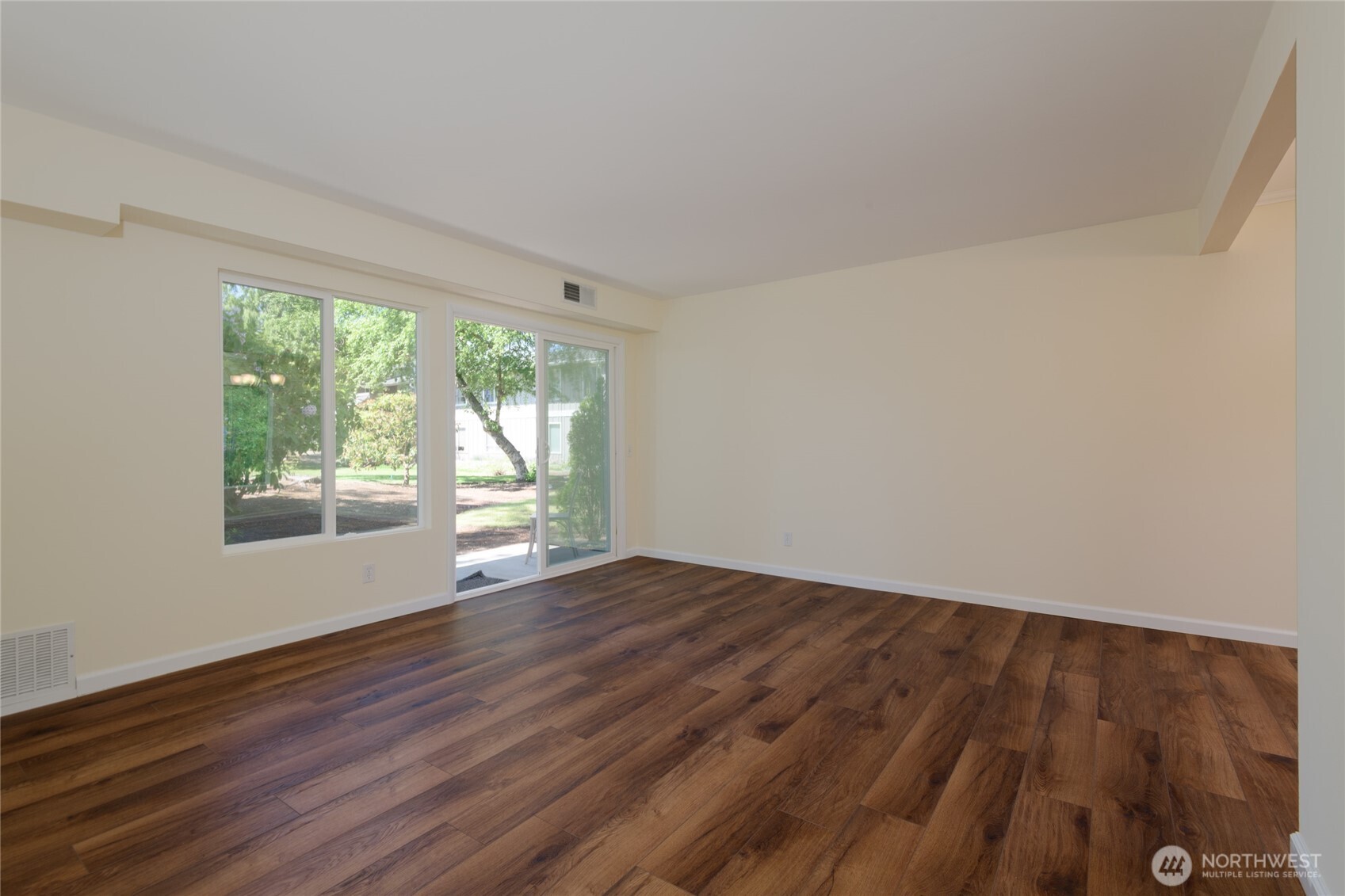 5029 84th Street Southwest Mukilteo, WA 98275 - Photo 8 of 16 a view of an empty room with wooden floor and a window