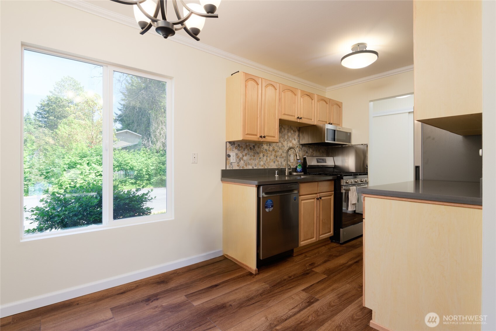 5029 84th Street Southwest Mukilteo, WA 98275 - Photo 9 of 16 a kitchen with granite countertop a stove top oven a sink and a refrigerator