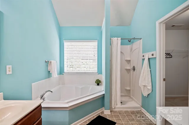 a bath room with a bath tub and a shower