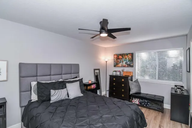 a bedroom with a large bed and a chandelier