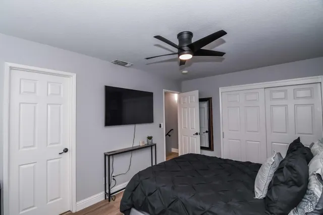 a bed room with a bed and a television