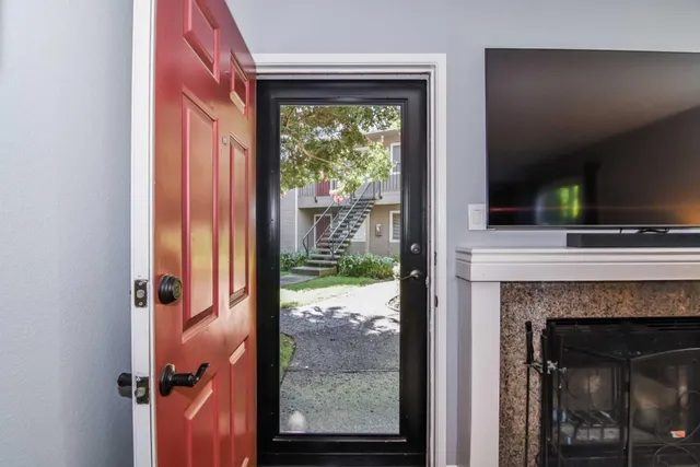 a living room with furniture and a potted plant