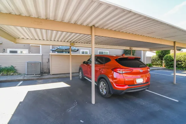 a backyard of a house with barbeque oven table and chairs