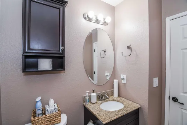 a kitchen with a refrigerator a stove a dining table and chairs