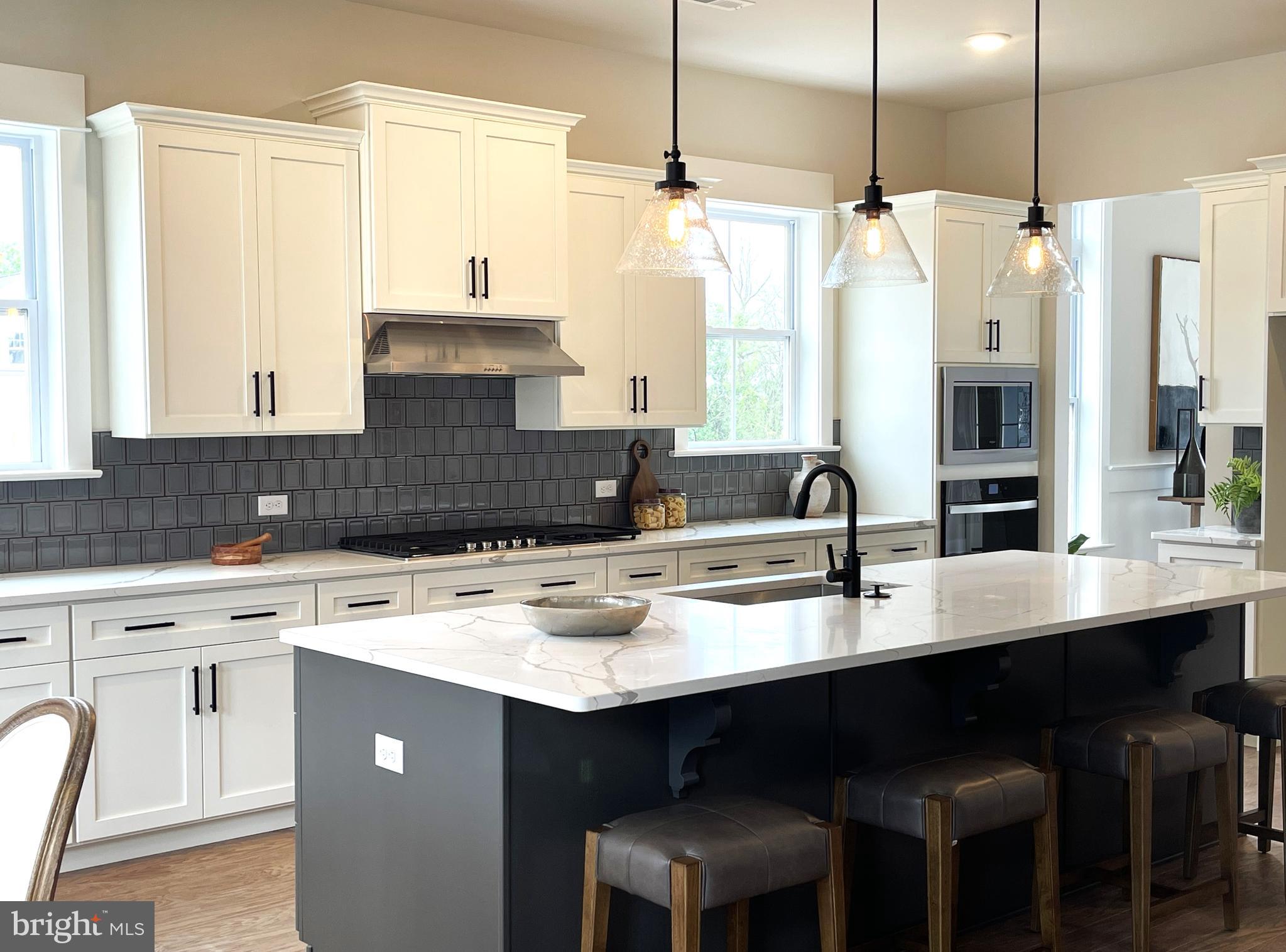 153 Lotus Lane Malvern, PA 19355 - Photo 4 of 29 a kitchen with a sink stove and white cabinets