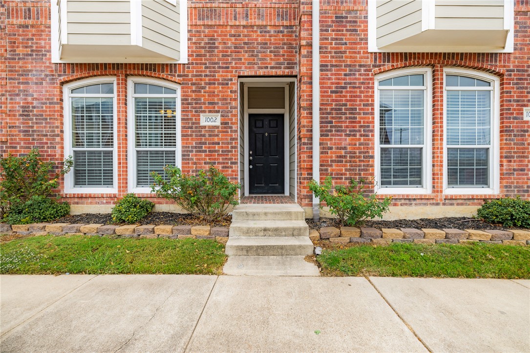 1198 Jones-Butler Road, Unit 1003 College Station, TX 77840 - Photo 24 of 42 a front view of a brick house many windows and yard