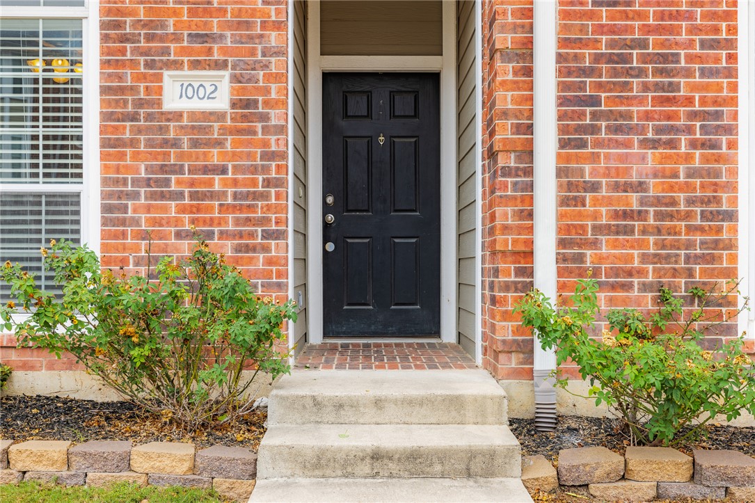 1198 Jones-Butler Road, Unit 1003 College Station, TX 77840 - Photo 25 of 42 a view of front door and potted plants