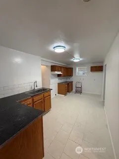 a kitchen with kitchen island a sink stove and wooden cabinets