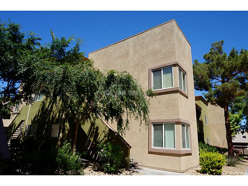 1846 North Decatur Boulevard, Unit 204 Las Vegas, NV 89108 - Photo 1 of 20 Facade/Exterior Front. Front of the building surrounded by trees and community pathways.