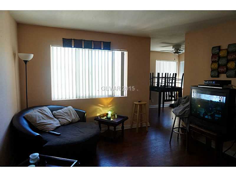 1846 North Decatur Boulevard, Unit 204 Las Vegas, NV 89108 - Photo 7 of 20 Living Room. Living room window and entrance to dining room.