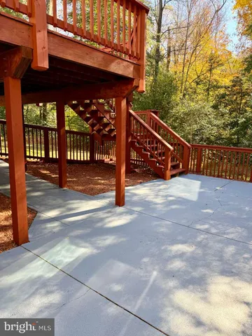a view of a house with a wooden deck