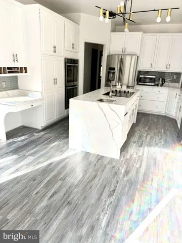 a kitchen with a sink and a refrigerator