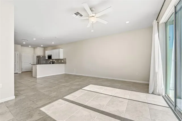 a view of a kitchen with a sink and a refrigerator