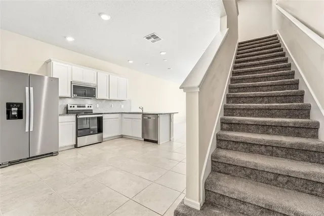 a view of kitchen with wooden floor and electronic appliances