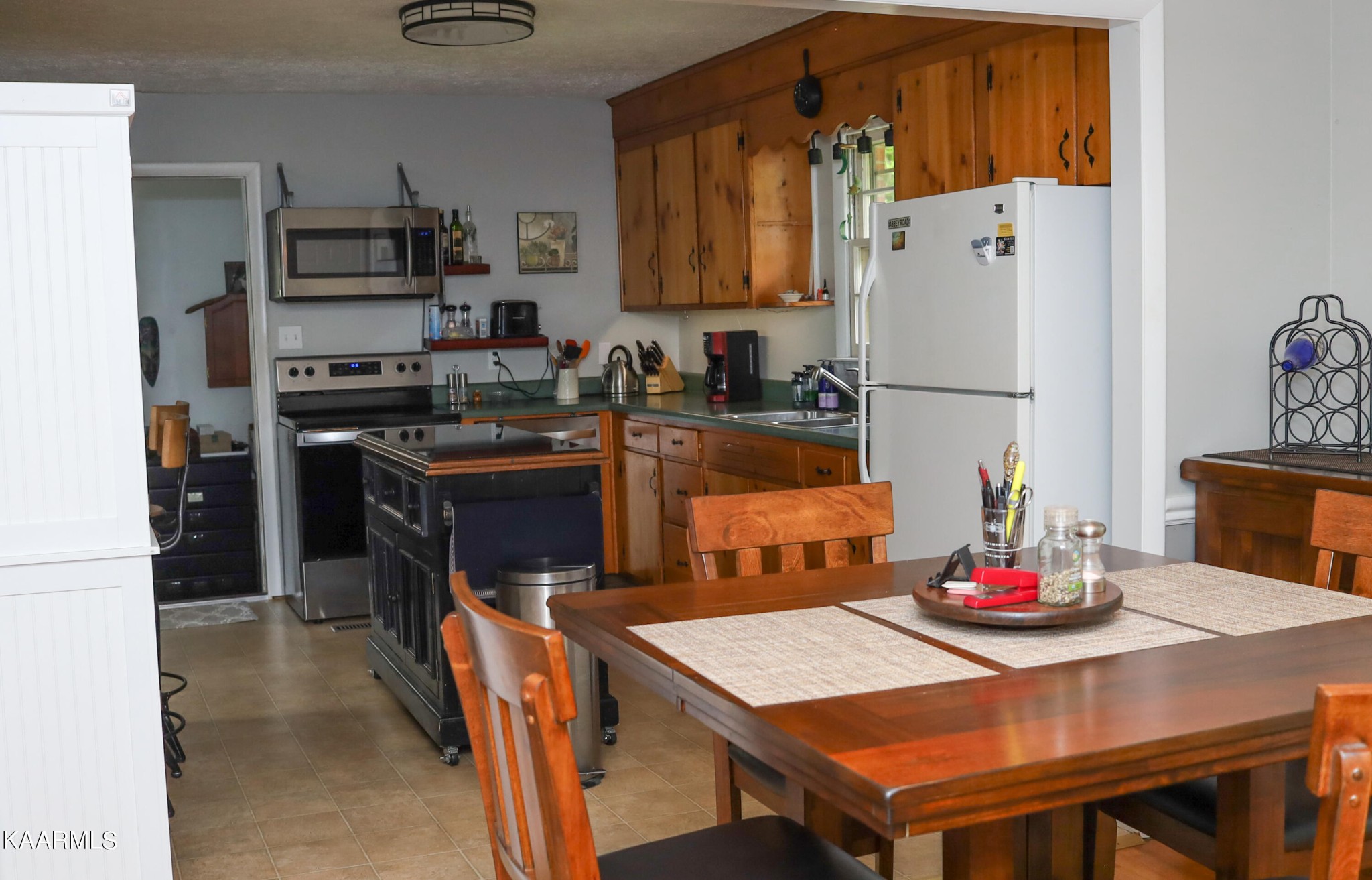 4105 Sullivan Road Knoxville, TN 37921 - Photo 25 of 45 a kitchen with stainless steel appliances granite countertop a refrigerator a stove a sink a dining table and chairs