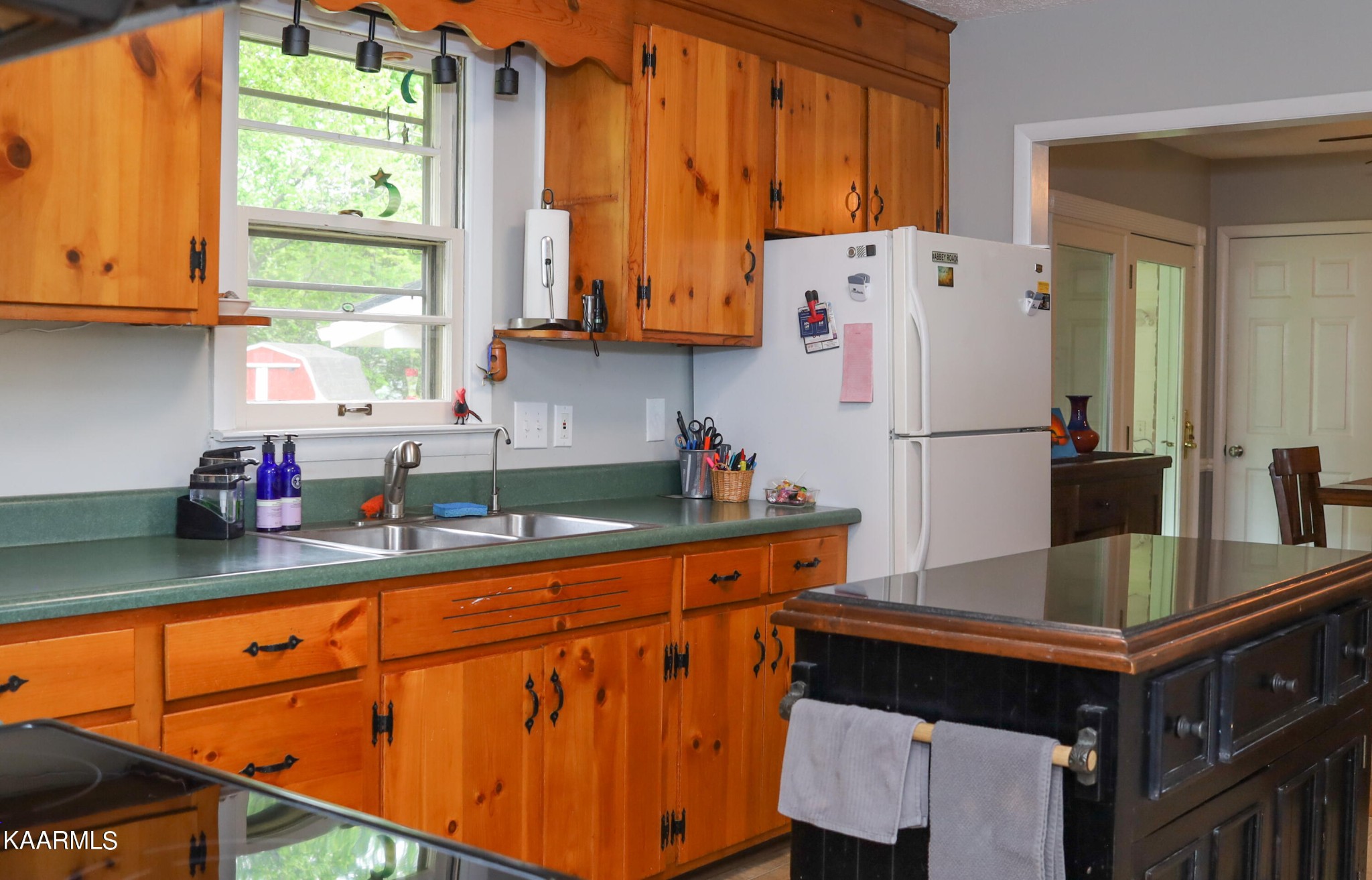 4105 Sullivan Road Knoxville, TN 37921 - Photo 27 of 45 a kitchen with stainless steel appliances granite countertop a refrigerator a sink dishwasher a stove and white countertops with wooden floor