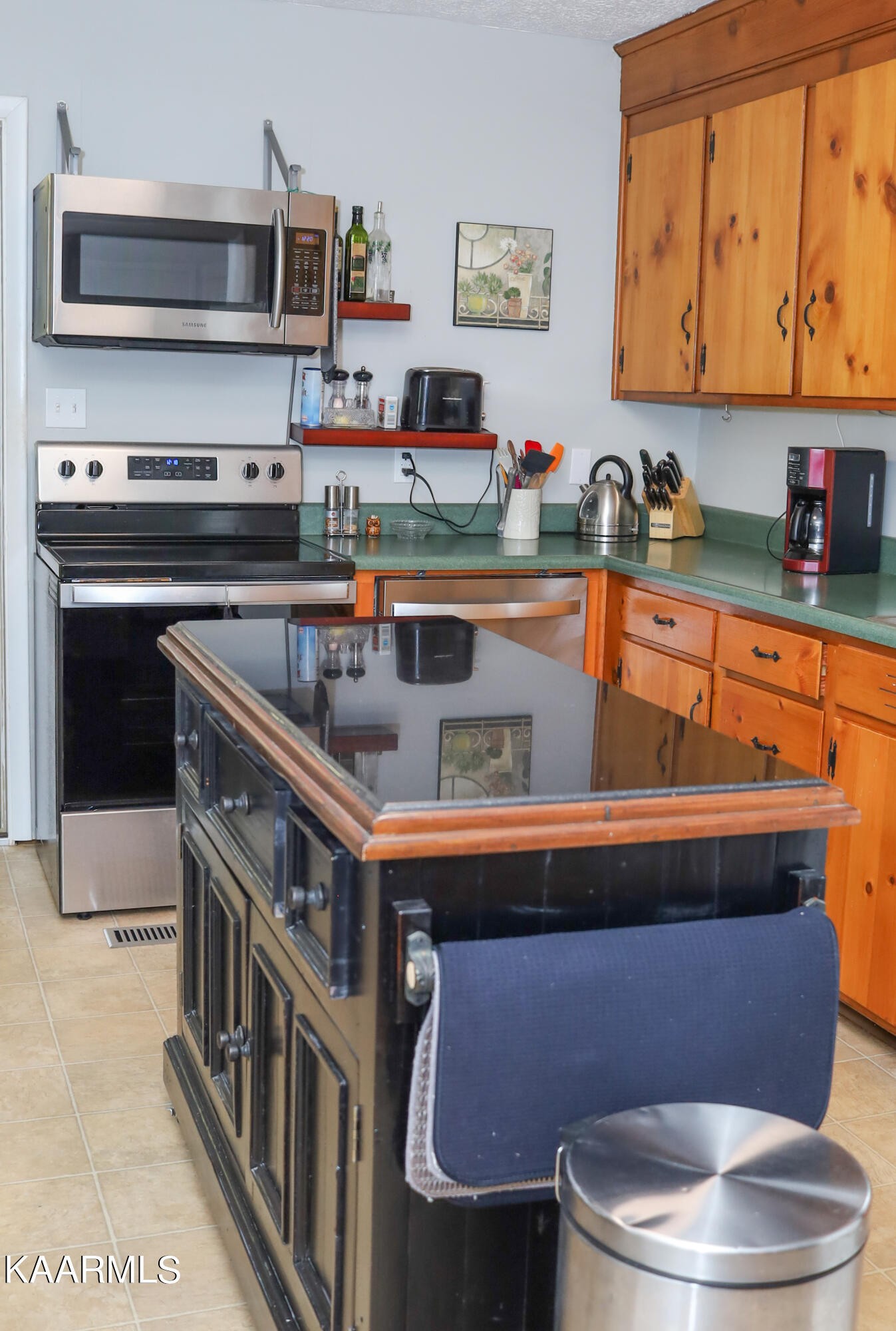 4105 Sullivan Road Knoxville, TN 37921 - Photo 29 of 45 a kitchen with stainless steel appliances a stove a microwave a sink and cabinets