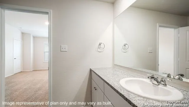 a bathroom with a sink and mirror