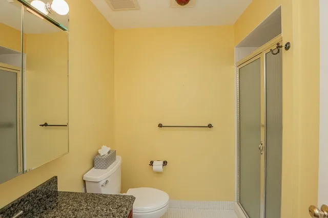 a bathroom with a toilet and a shower