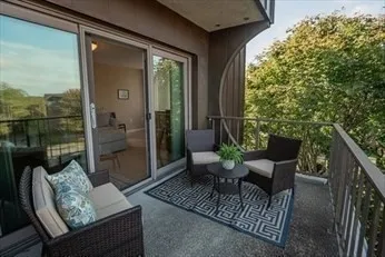 a view of a porch with furniture and a yard