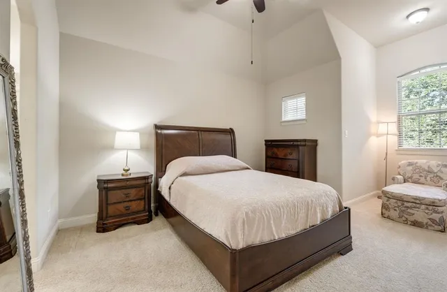 a bedroom with a bed and dresser