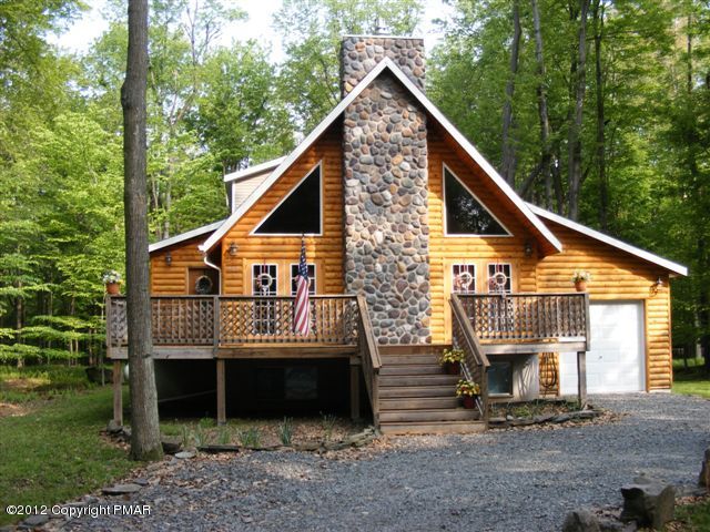 a view of a house with a yard and wooden fence
