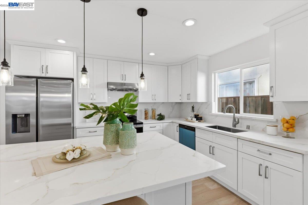 4519 Edwards Lane Castro Valley, CA 94546 - Photo 13 of 46 a kitchen with a refrigerator a sink a counter space and stainless steel appliances