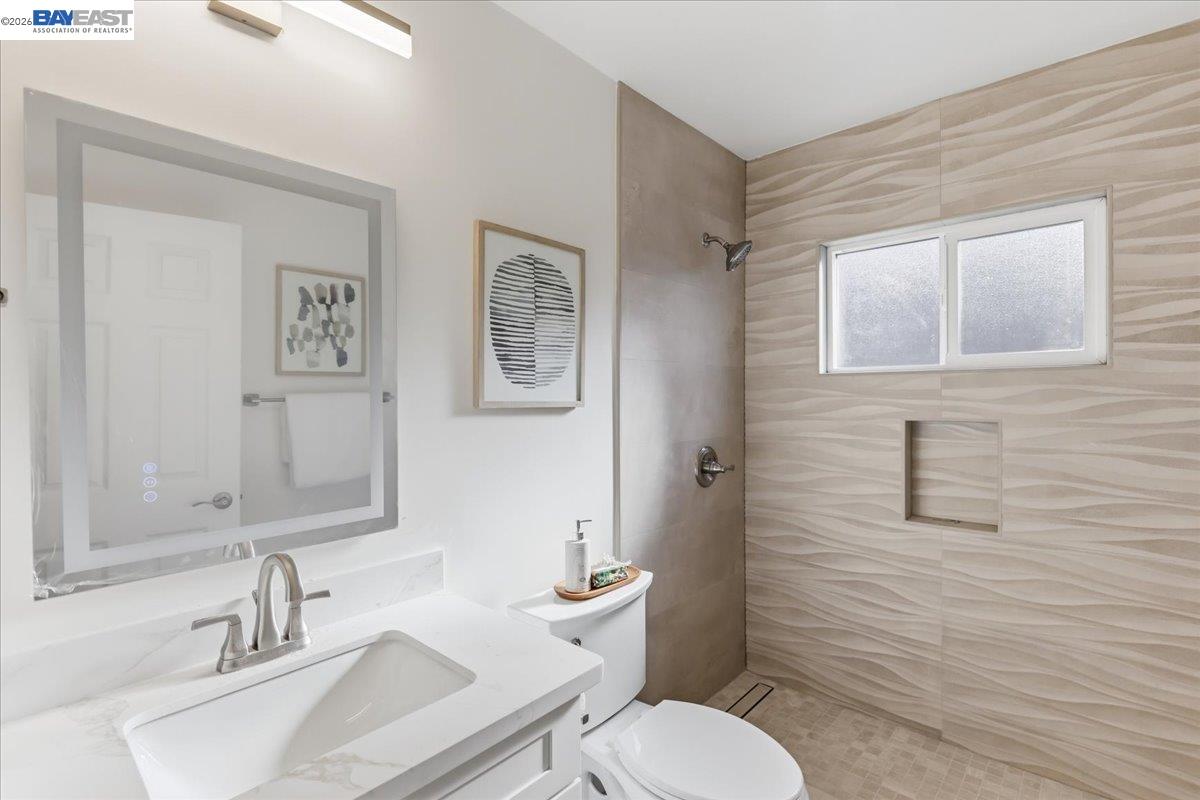 4519 Edwards Lane Castro Valley, CA 94546 - Photo 22 of 46 a bathroom with a toilet a sink and mirror