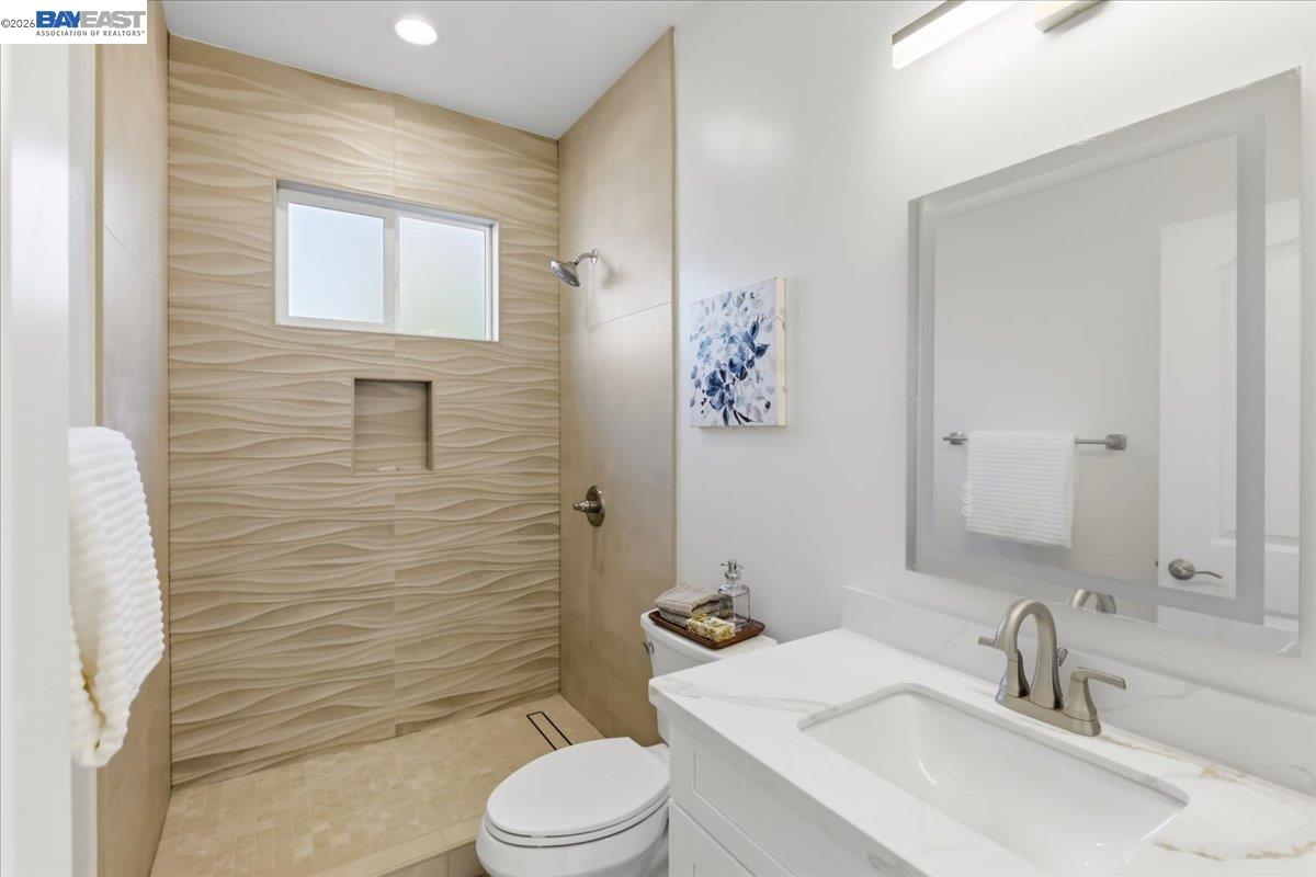 4519 Edwards Lane Castro Valley, CA 94546 - Photo 37 of 46 a bathroom with a sink a toilet and shower