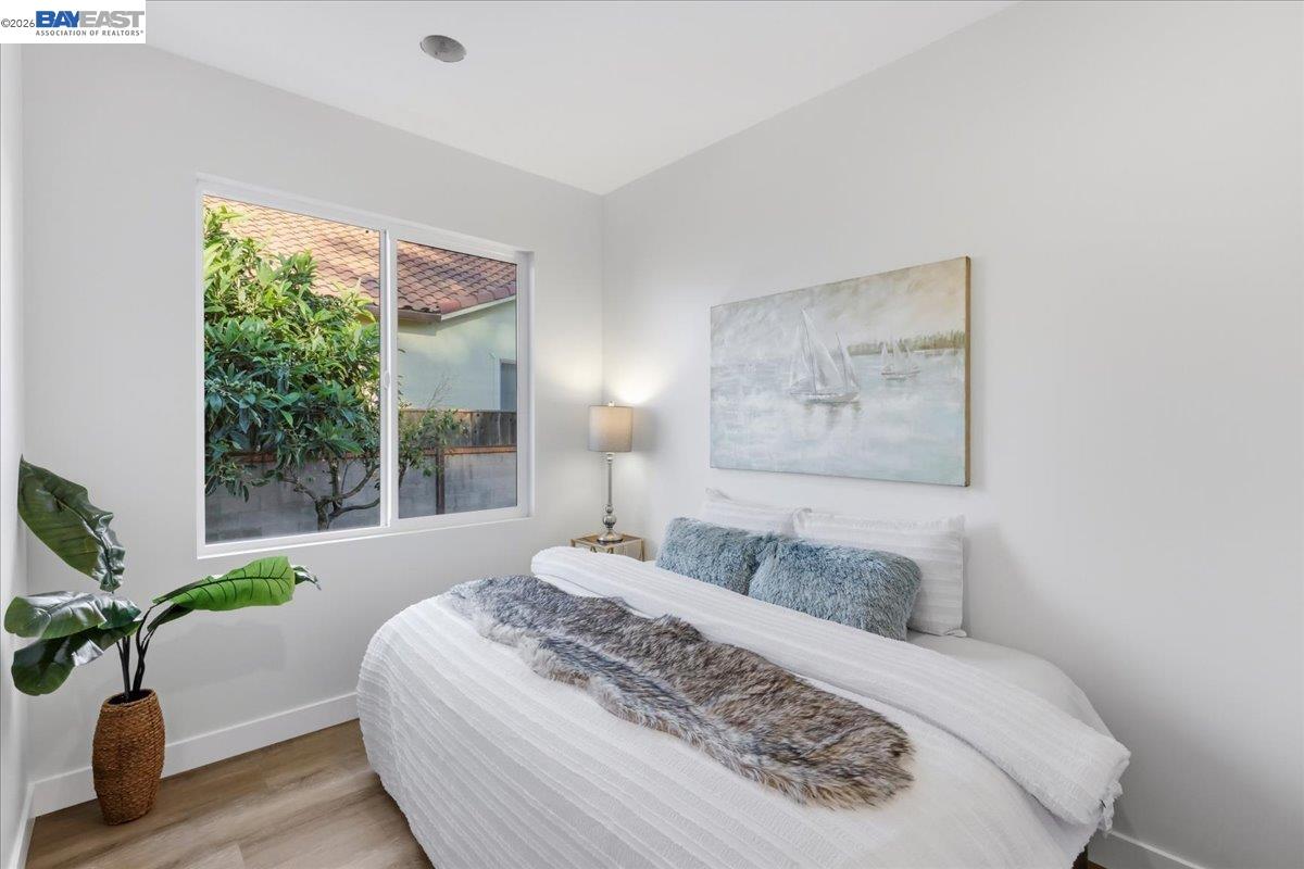 4519 Edwards Lane Castro Valley, CA 94546 - Photo 39 of 46 a bedroom with a large bed and a potted plant