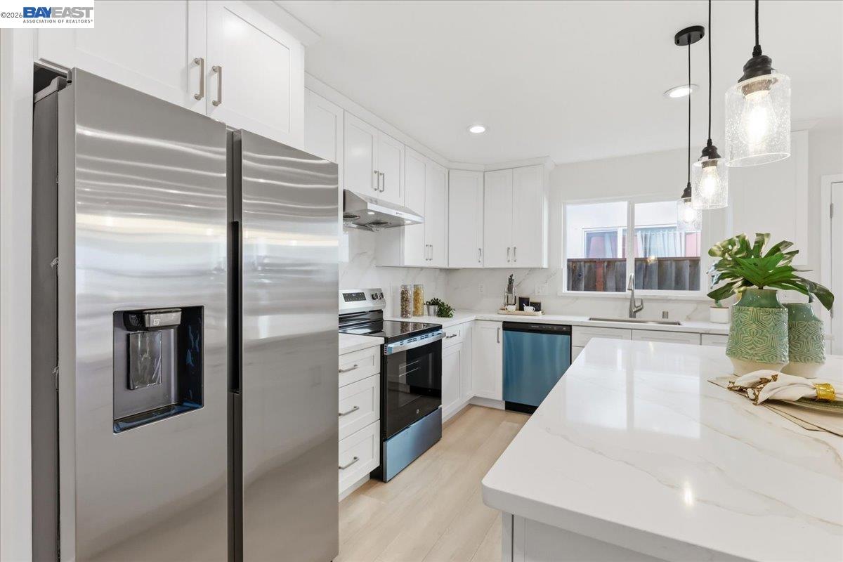 4519 Edwards Lane Castro Valley, CA 94546 - Photo 10 of 46 a kitchen with kitchen island a counter top space a sink stainless steel appliances and cabinets