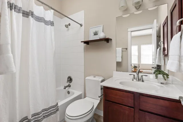 a bathroom with a toilet a sink and a mirror