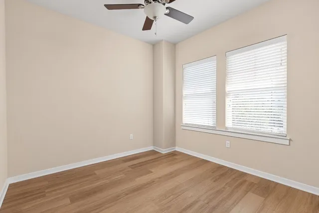 wooden floor in an empty room with a window