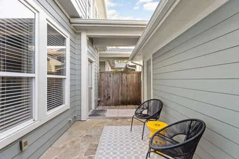 a view of a two chairs in the balcony